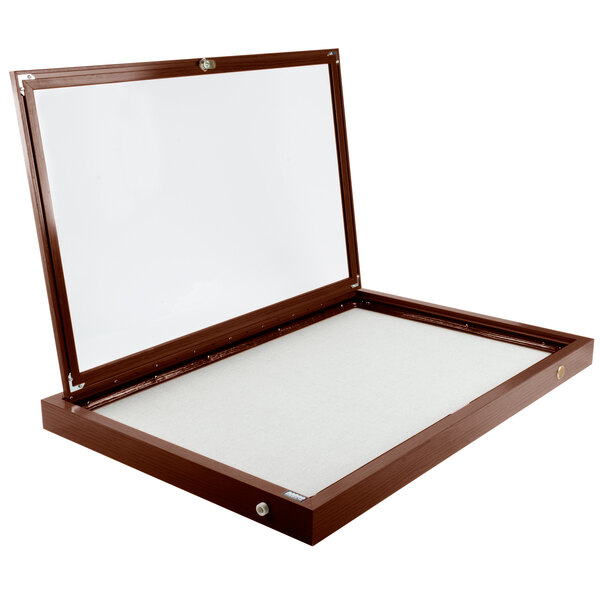 A walnut finished wooden cabinet with a white board inside.