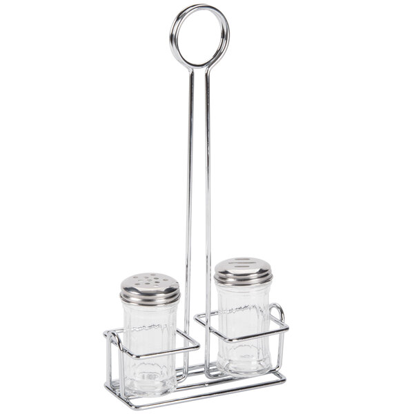 A round metal stand holding two glass salt and pepper shakers with silver tops.