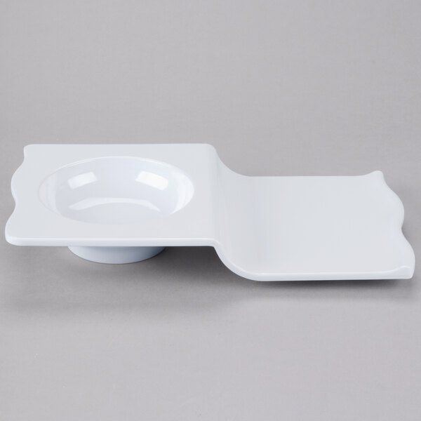 A white plate with a curved edge.