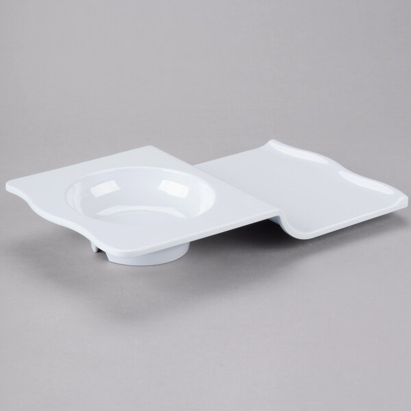 a white square plate with a hole in the middle