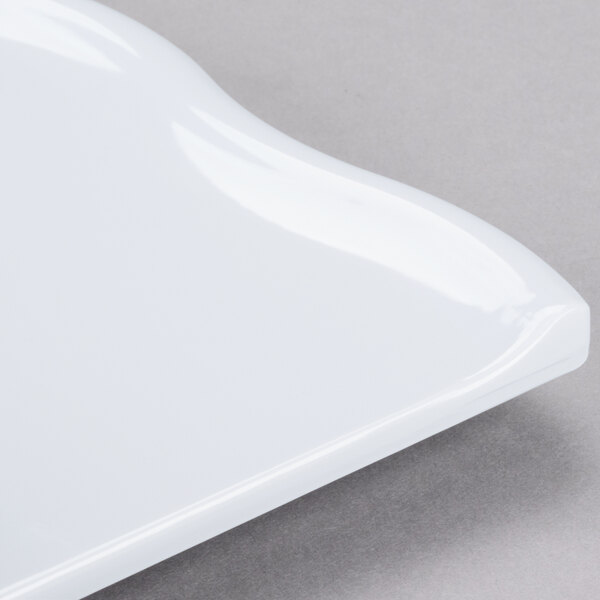 A white GET San Michele tapas plate with a curved edge.