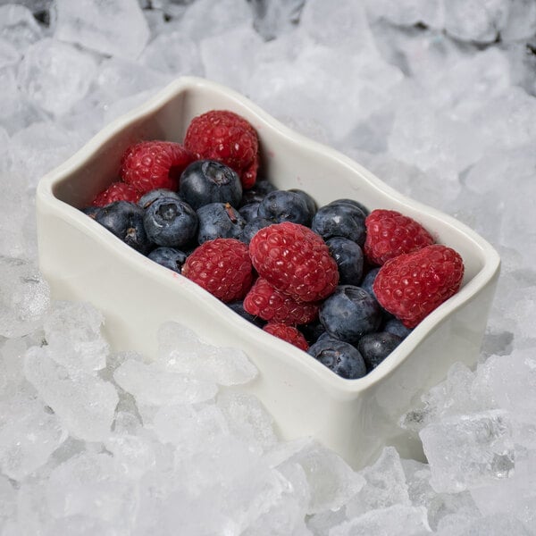 A GET Create-a-Bar deli crock filled with blueberries and raspberries on ice.