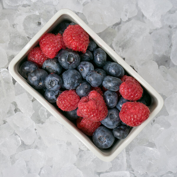 A GET Create-a-Bar Deli Crock filled with blueberries and raspberries on a table.