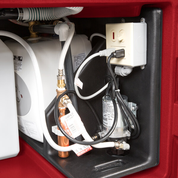 A red Cambro CamKiosk portable hand sink with a water heater and electrical outlets.