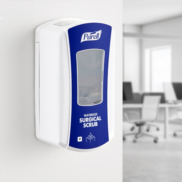 A blue and white Purell LTX waterless surgical scrub dispenser on a wall.