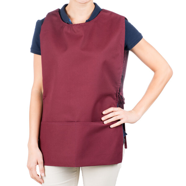 A woman wearing a burgundy Intedge cobbler apron.