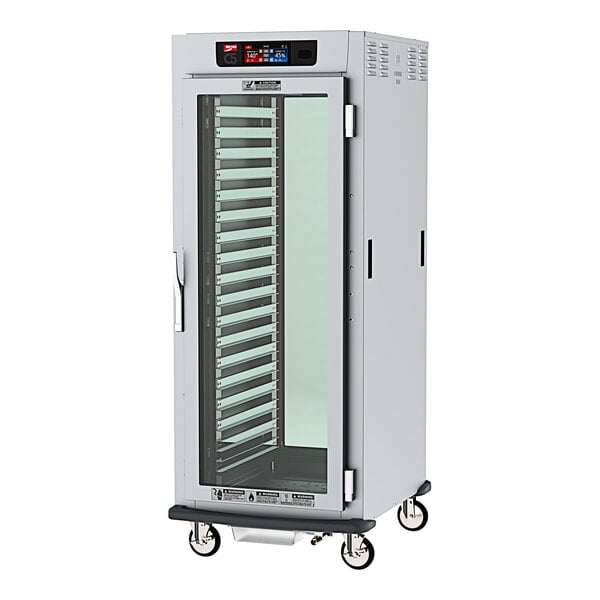 A white cabinet with clear glass doors on wheels.