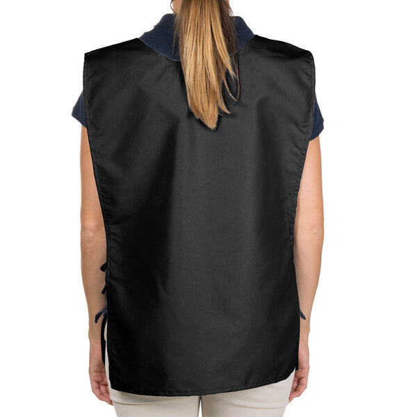 A woman wearing a black Intedge cobbler apron with two pockets.