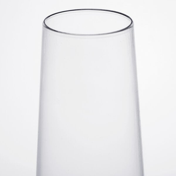 A clear plastic stemless flute with a clear rim.