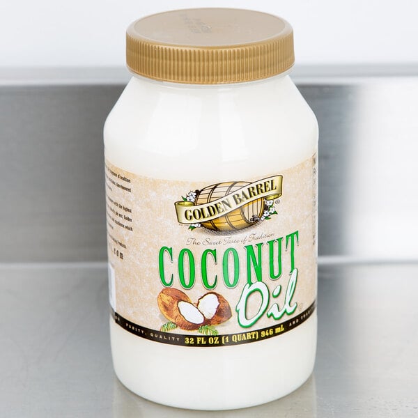 A case of 12 Golden Barrel 32 oz. bottles of coconut oil on a white counter.