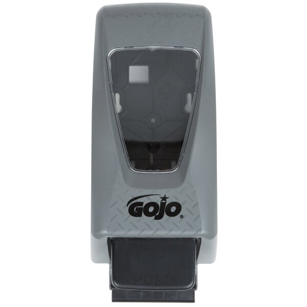 A close-up of a grey plastic GOJO® dispenser with a black handle.