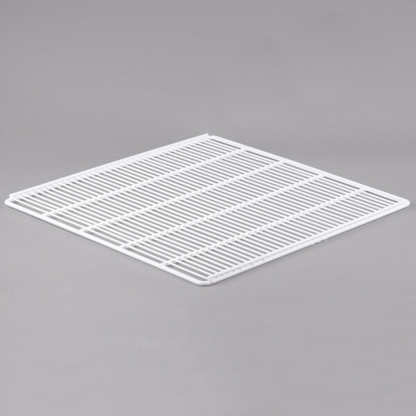 A white polyethylene-coated wire shelf grid on a gray surface.