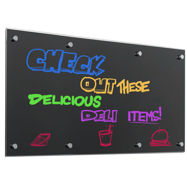 A black Pure Glass markerboard with colorful writing on it on a counter in a deli.