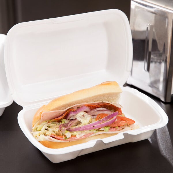 A sandwich in a white Genpak foam hinged lid container.