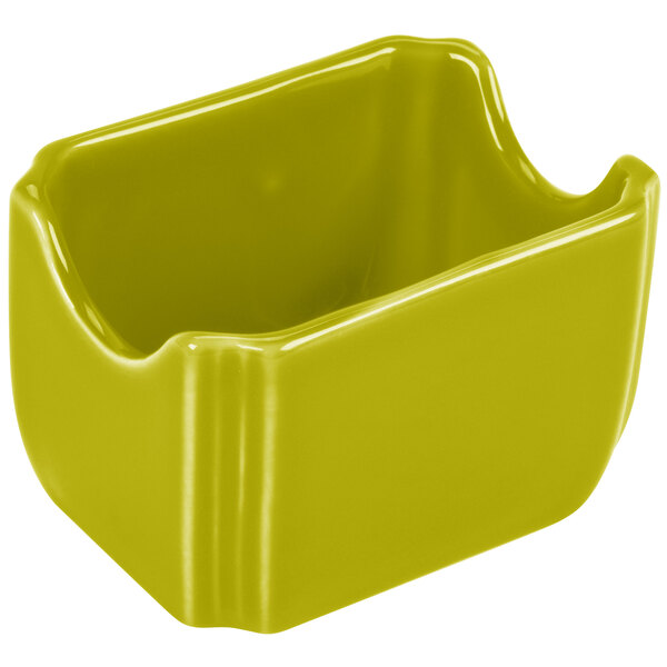 A green ceramic Fiesta sugar caddy with a lid on a counter.