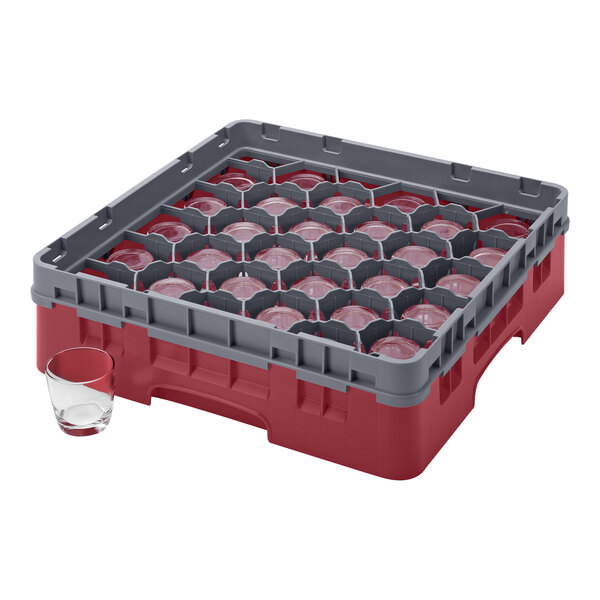 A red and gray plastic Cambro glass rack with glasses inside.