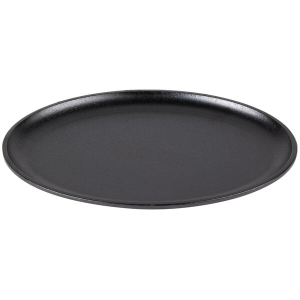 A black oval cast iron skillet on a white background.