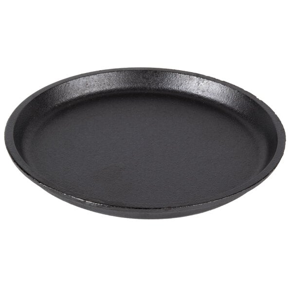 A close-up of a black round Lodge cast iron fajita skillet.