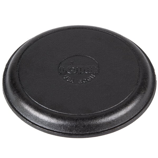 A black round Lodge cast iron fajita skillet with a circular handle.