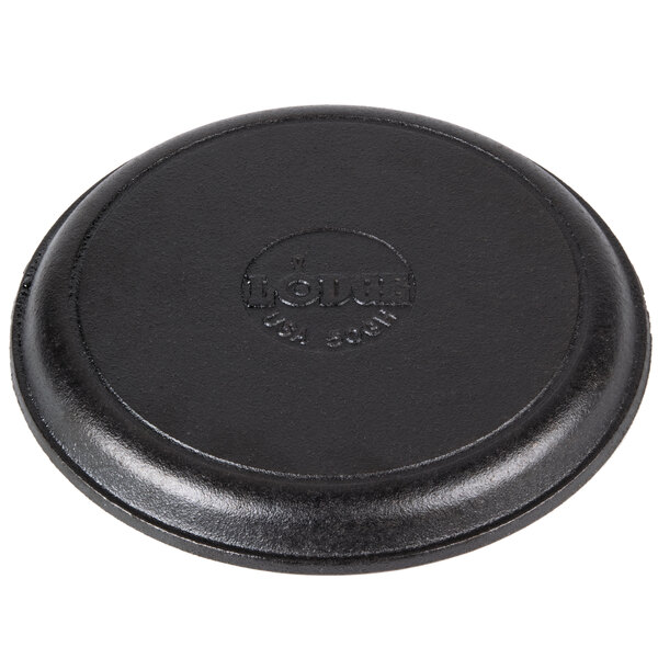 A black round Lodge cast iron fajita skillet with a circular hole in the handle.
