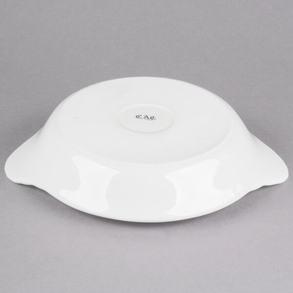 A white stoneware shirred egg dish with a lid on it.