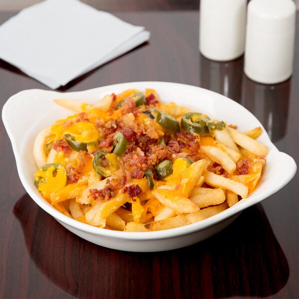 A bowl of macaroni and cheese with bacon and jalapenos in a white stoneware dish.