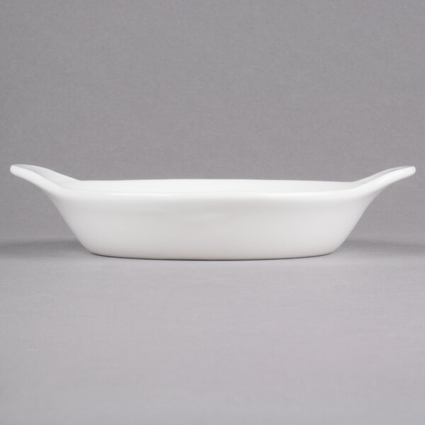 An oval white stoneware dish with handles.