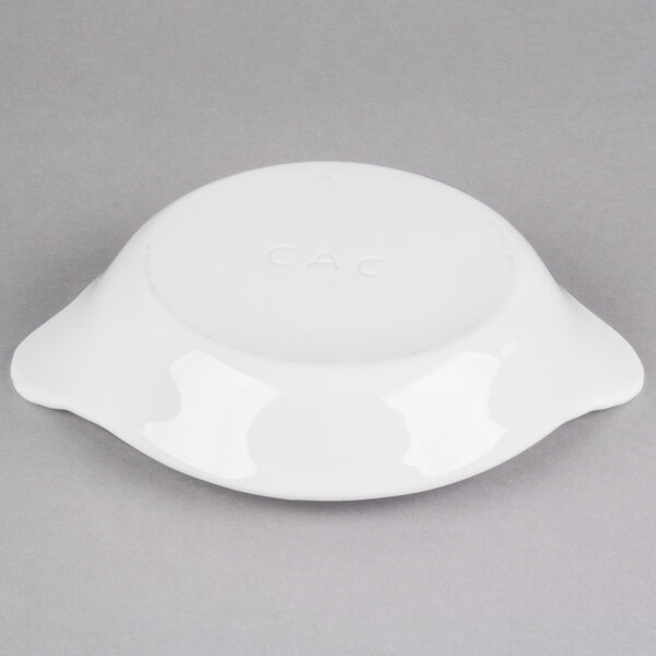 A white stoneware shirred egg dish with handles.