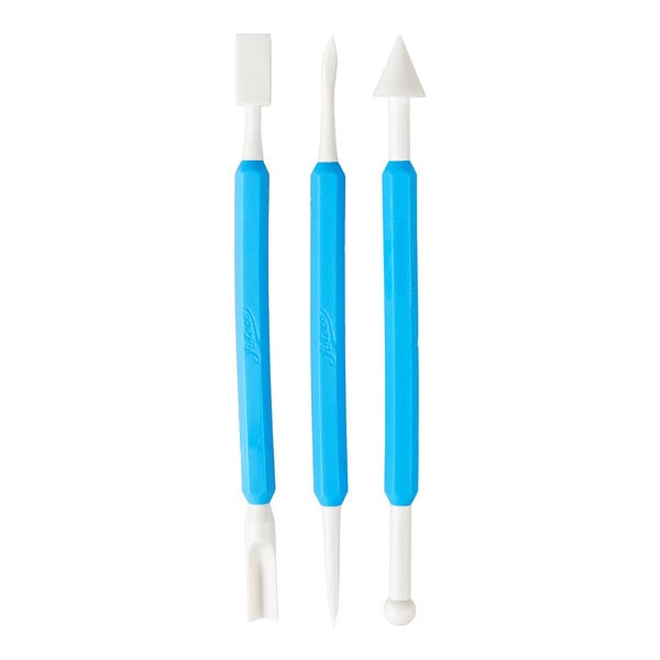 Three double-ended sculpting tools with blue handles and various white tips, including a flat square, pointed, triangular, forked, and rounded shapes.