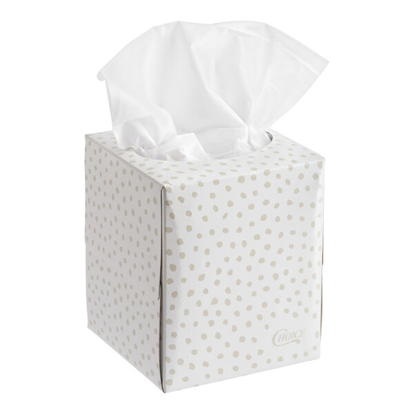 A cube-shaped box of facial tissues with a white and beige dotted design.