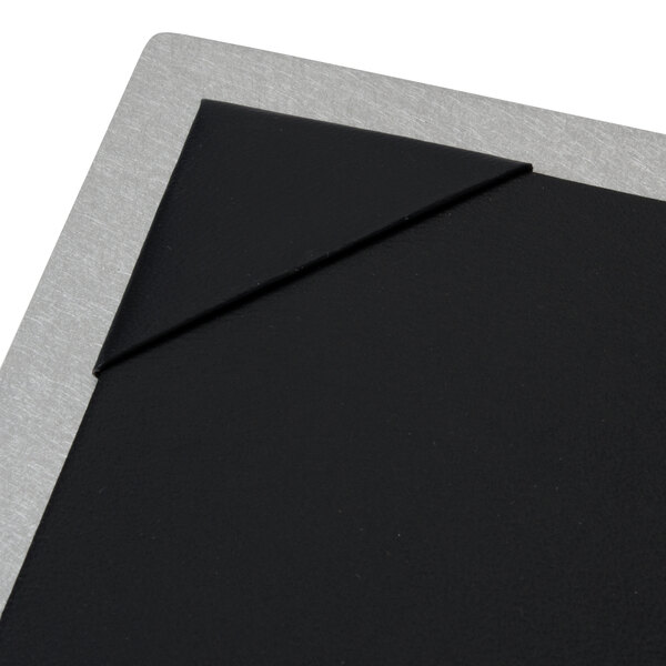 A Menu Solutions brushed aluminum menu board with picture corners on a black board.