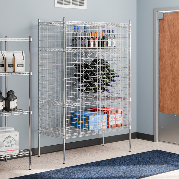 A Regency chrome wire security cage with shelves holding bottles.