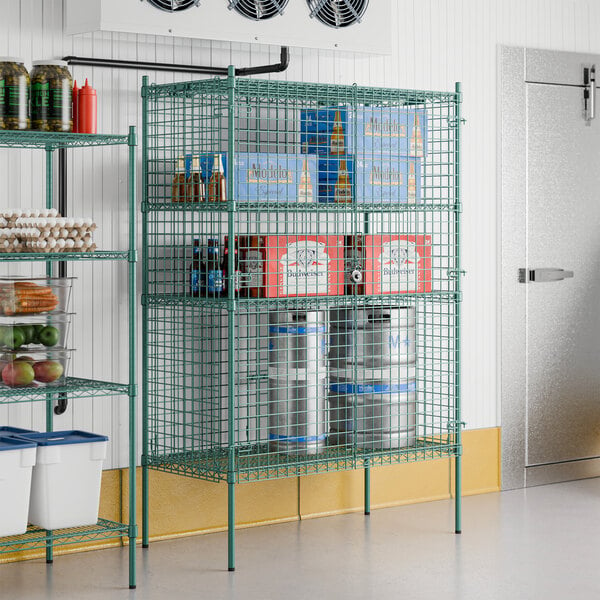 A Regency green wire security cage kit with shelves holding food items.