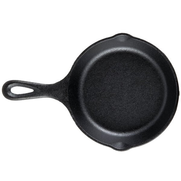 A black Lodge mini cast iron skillet with a handle.