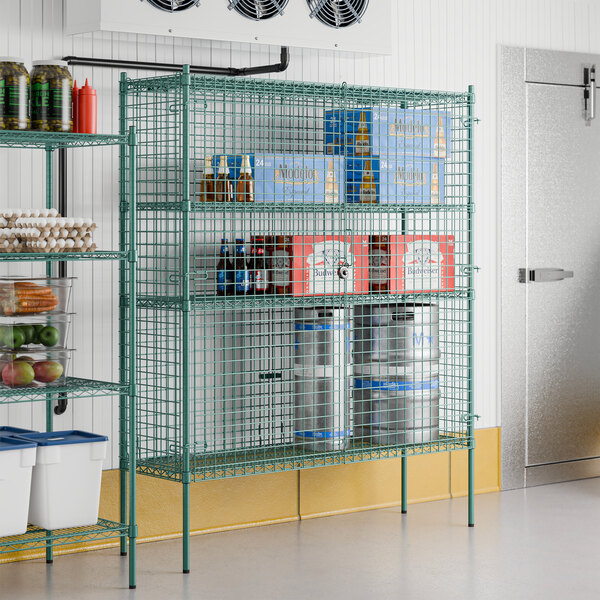 A Regency green wire security cage kit on stationary wire shelving holding food items.