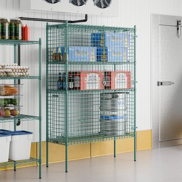 A Regency green metal wire security cage kit with shelves.