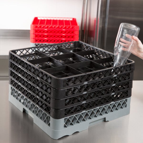 Gray plastic glass rack with 4 black extenders on equipment table