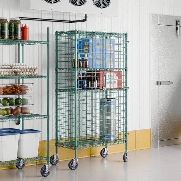 A Regency green metal wire security cage kit in a room with shelves of food items.