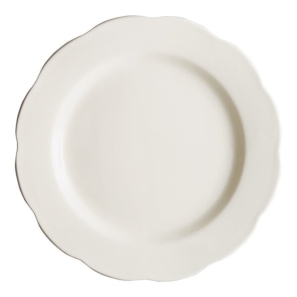 An Acopa ivory stoneware plate with a scalloped edge.