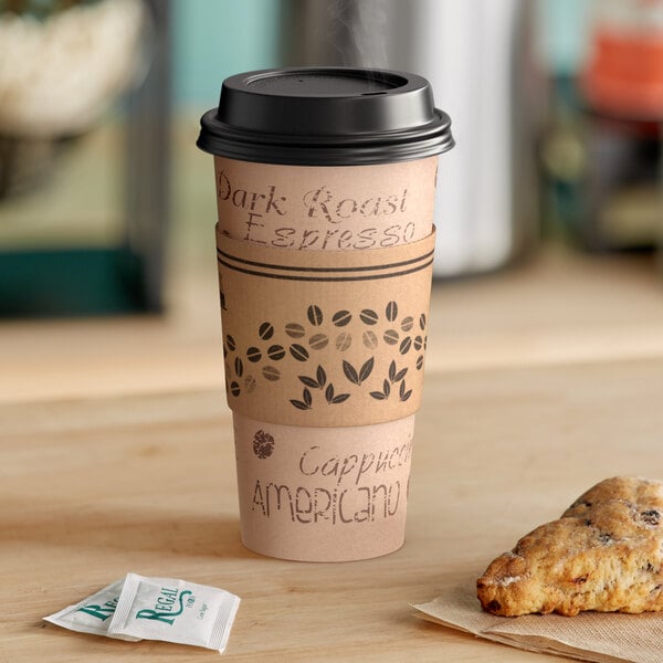 A Choice paper hot cup with a black lid and a sleeve on a table with a pastry.