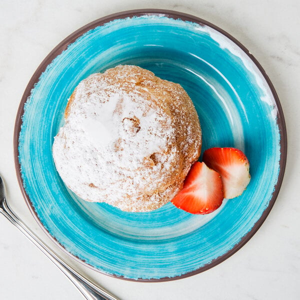 A Carlisle aqua melamine bread and butter plate with a pastry on it.