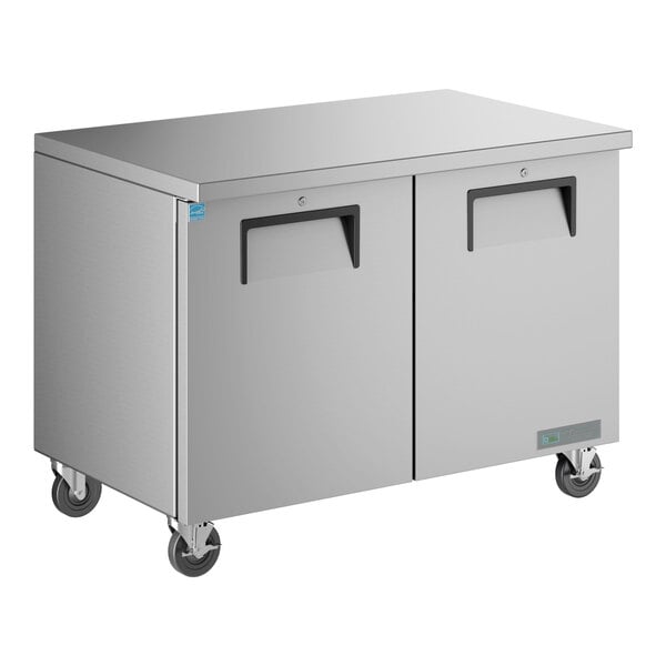 A stainless steel True undercounter refrigerator with black handles.