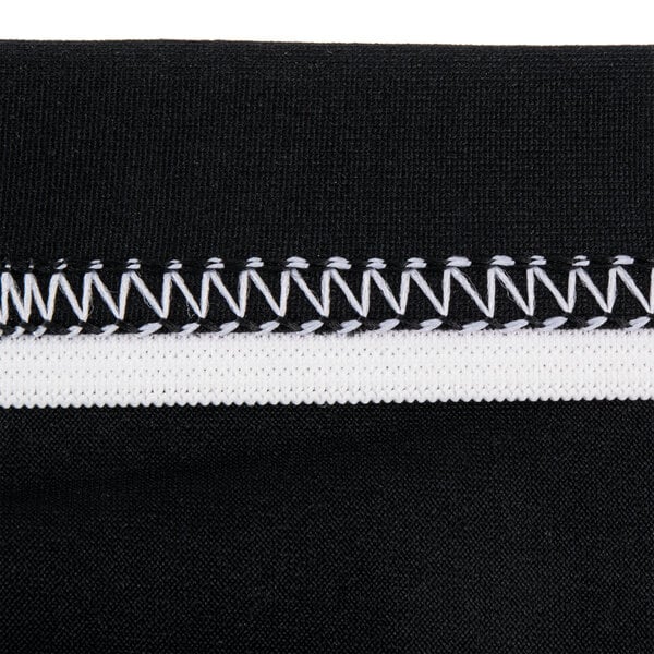 A close up of a black spandex table cover with a zipper.