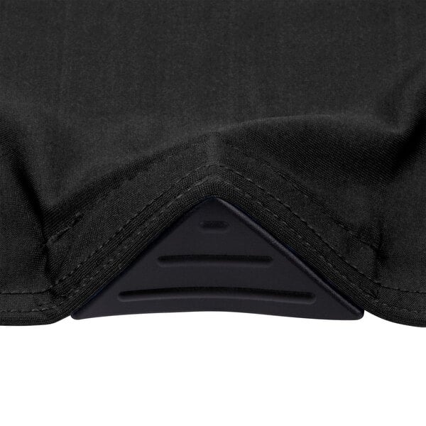 A close up of a black table cover with a black triangle on it.