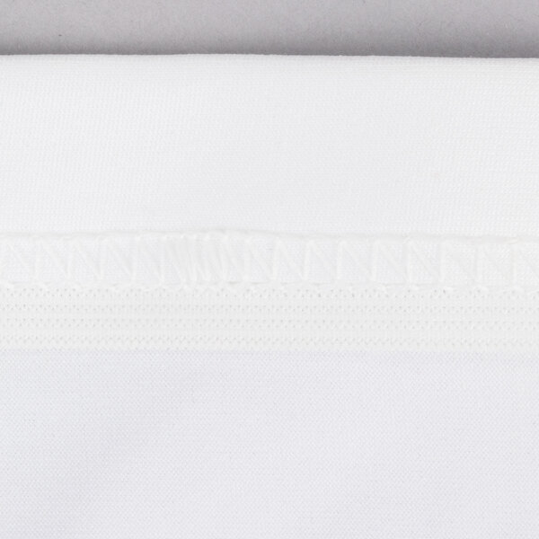 A close up of a white spandex fabric with a small white thread.