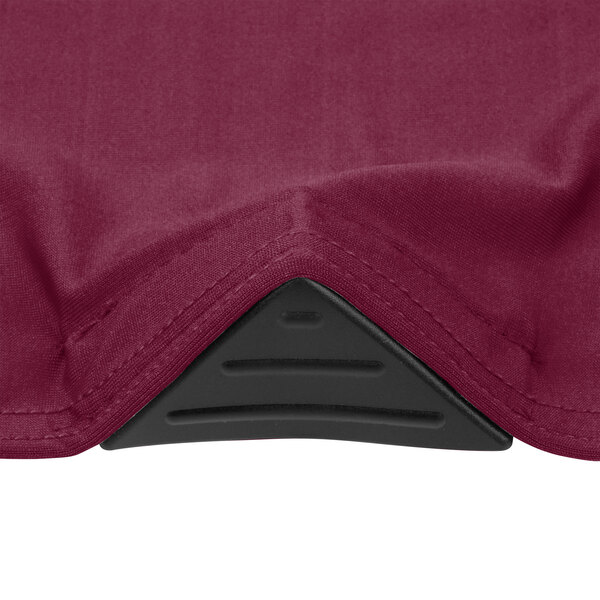 A close up of a red fabric corner on a Snap Drape Contour table cover.