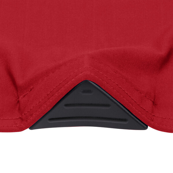 A crimson Snap Drape Contour table cover on a round table in a bar.