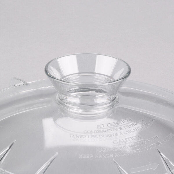 A clear glass lid for a Robot Coupe bowl.