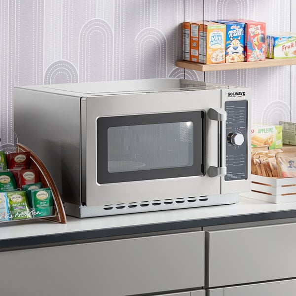 A Solwave commercial microwave on a counter with food inside.