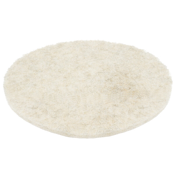 A white round floor pad with black hair.
